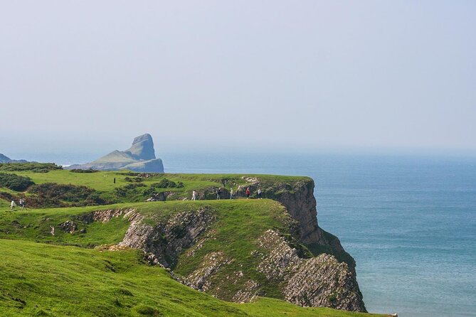 Cardiff: Gower Peninsula's Cliffs Scenic Day Tour - Bracelet Bay and the lighthouse on an islet