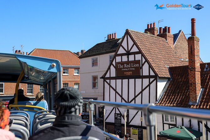 Golden Tours York Hop-on Hop-off Open Top Bus Tour with Audio Guide - Audio guide in English, with dry humor in the mix