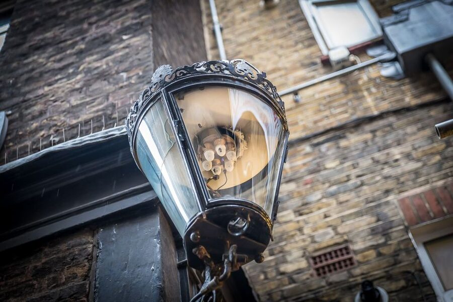 Secrets of London Walking Tour - Dickens-style atmosphere: gas lamps, pub door knockers, and hidden signs